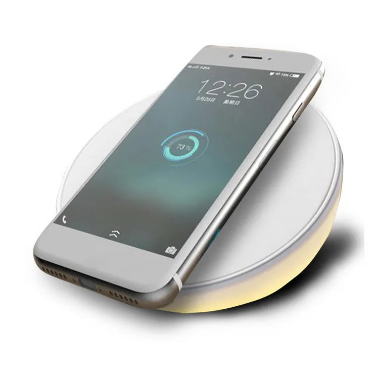 White slim QI wireless charger with LED clock display for mobile phones.