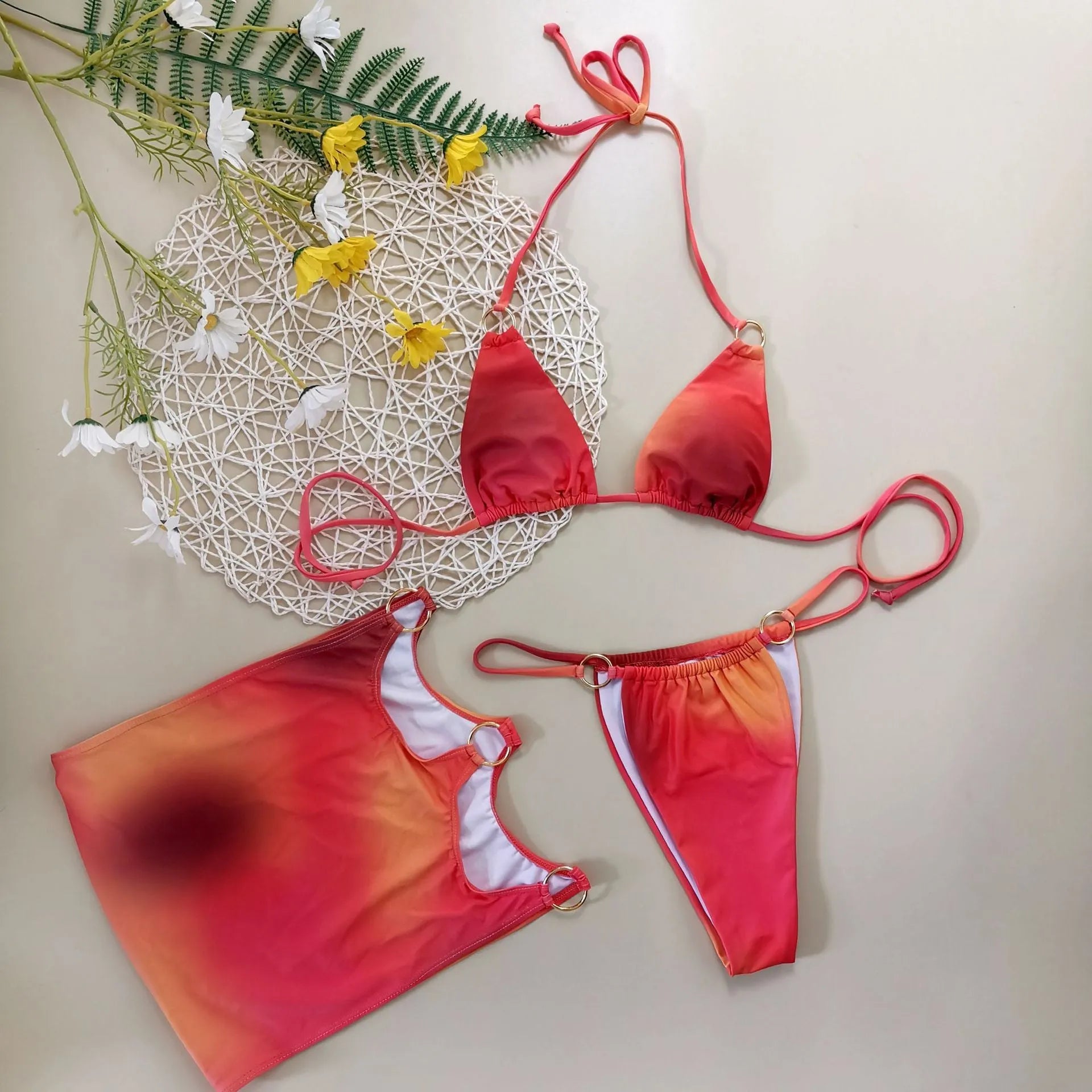 Tie-dye gradient halter bikini three-piece swimwear set with skirt cover-up on mannequin