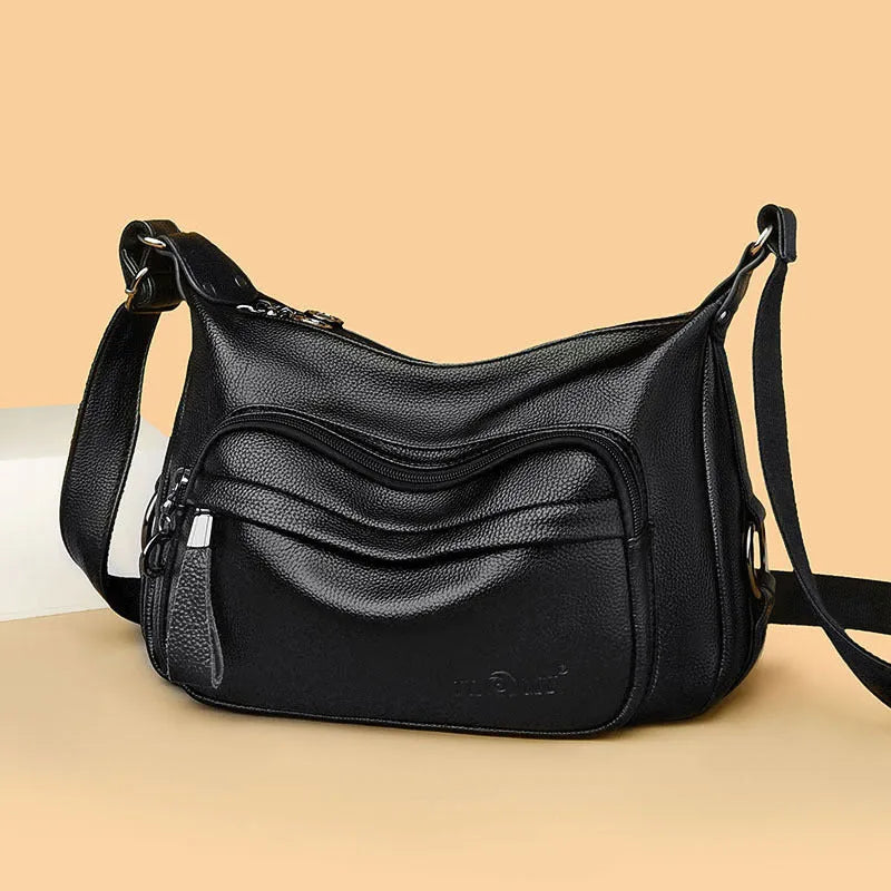 Large blue soft PU women's shoulder bag with a zipper and organised interior compartments.