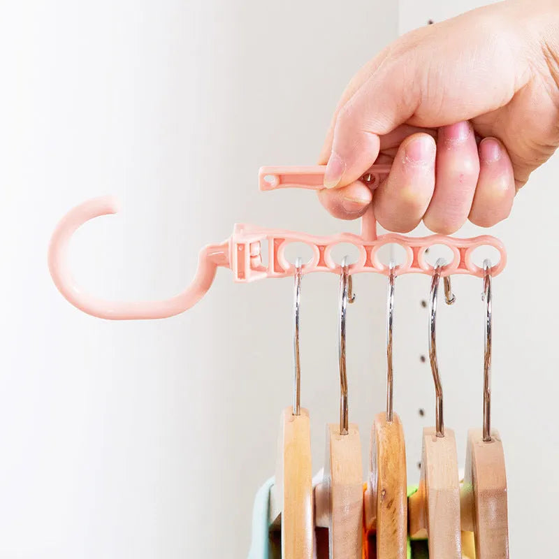 Blue revolving wardrobe hanger with five rotating branches and a central handle.