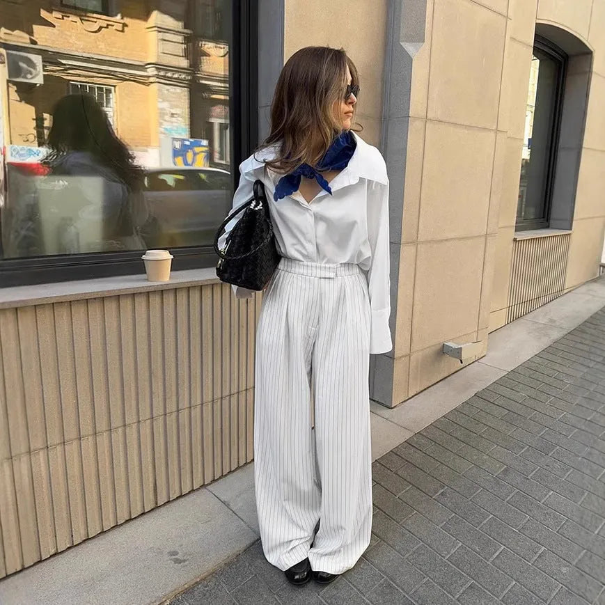 White striped wide-leg loose fit women's trousers with a zip fastening on a mannequin