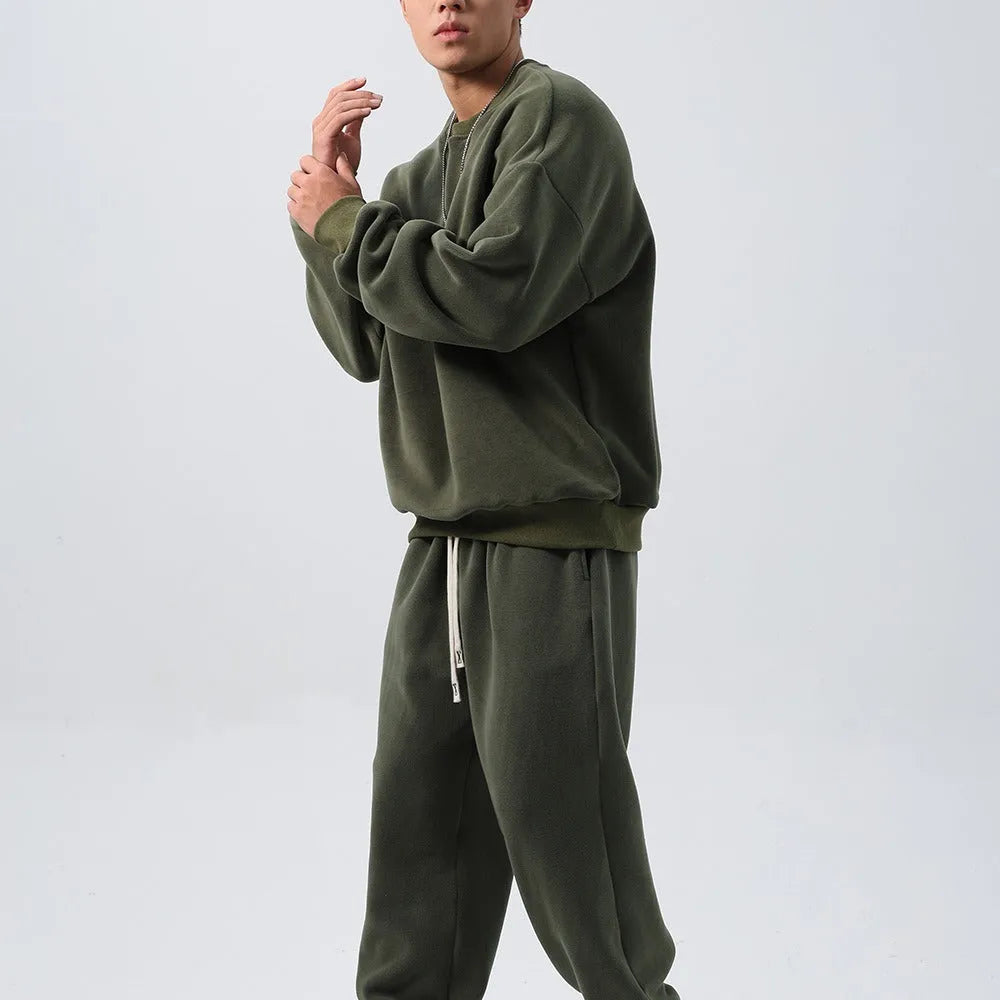 Men's polar fleece sports suit set showing crew neck top with long sleeves and matching padded trousers in winter colours