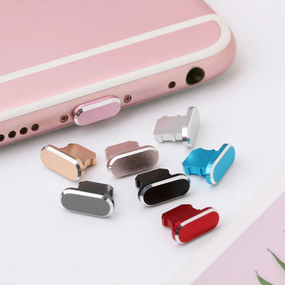 Aluminium alloy iPhone charging port dust plug in multiple colours including gold, silver, blue, red, grey, black, and rose gold.