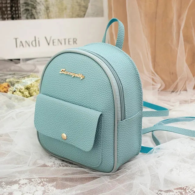Small black PU women's shoulder backpack with zipper closure showing compact dimensions