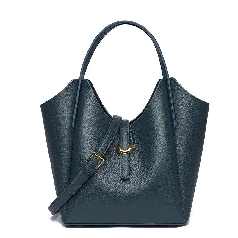 Genuine leather retro bucket handbag for women in beige, showing sewn thread detail and handheld straps.