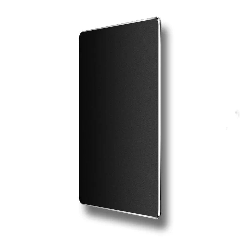 Double-sided aluminium non-slip mouse pad in black on a desk with a mouse and keyboard