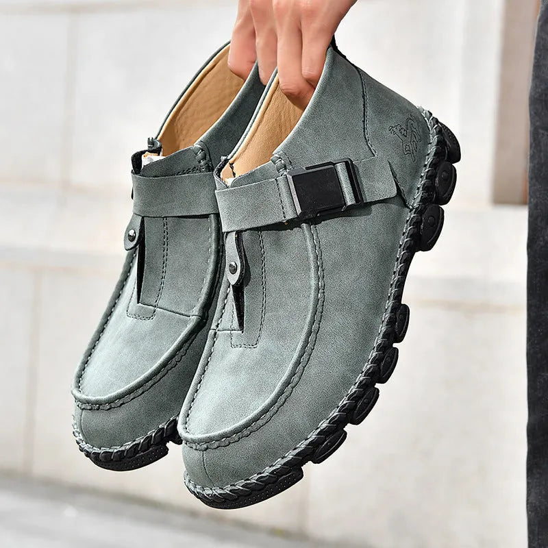 Black casual PU leather slip-on loafers with visible handmade stitching on a flat, low-heel sole.