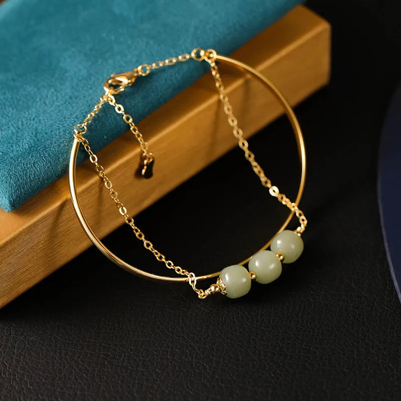 Women's jade lucky beads bracelet with gold inlay in single, double, and three bead versions.