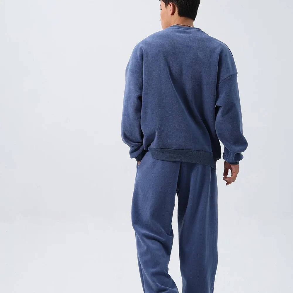 Men's polar fleece sports suit set showing crew neck top with long sleeves and matching padded trousers in winter colours