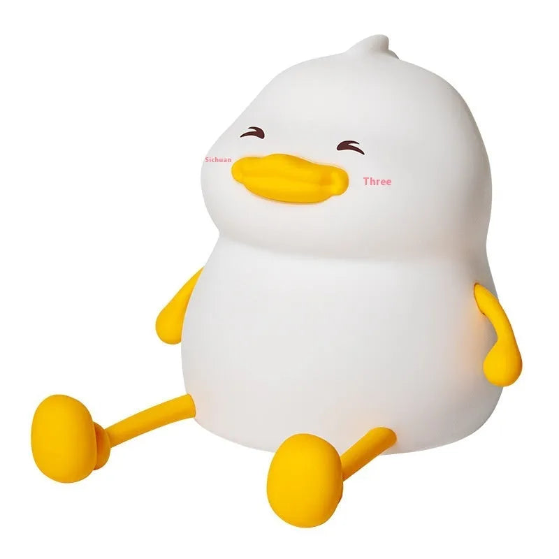 Chubby small night lamp with silicone pat design and integrated phone holder on desk