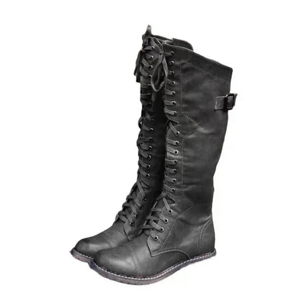 Women's black chunky heel high leg boots with a round toe and low block heel on a white background.