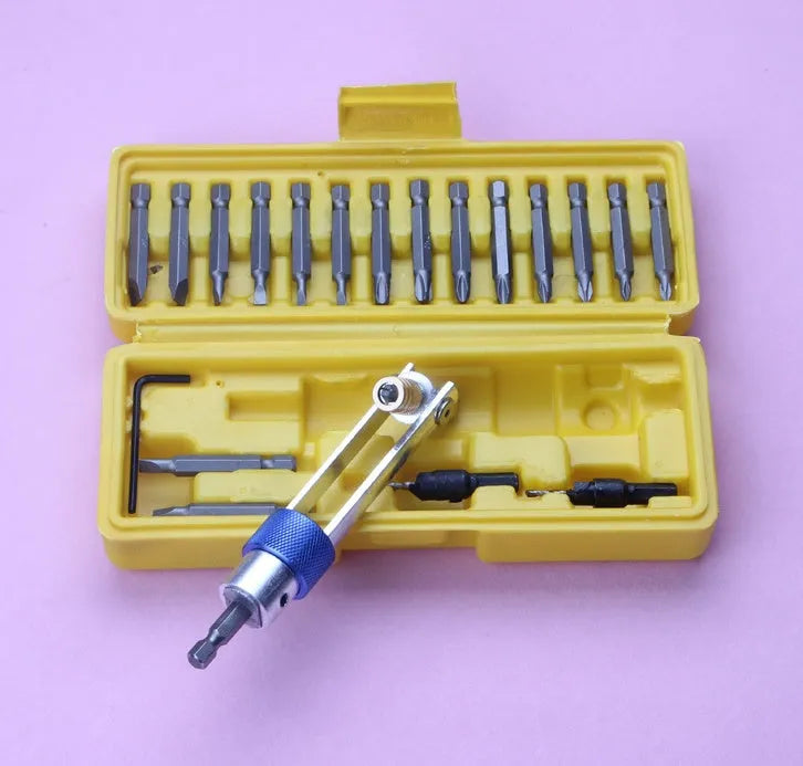Half Time Drill quick-change bit set with driver, Phillips bits, flathead bits, and countersink bits on a workbench.