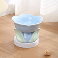 Blue floral patterned ceramic raised bowl for cats or small dogs on a non-slip base.