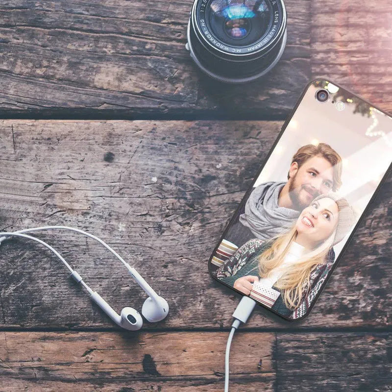 Patterned iPhone case with raised edges on a table next to an iPhone.