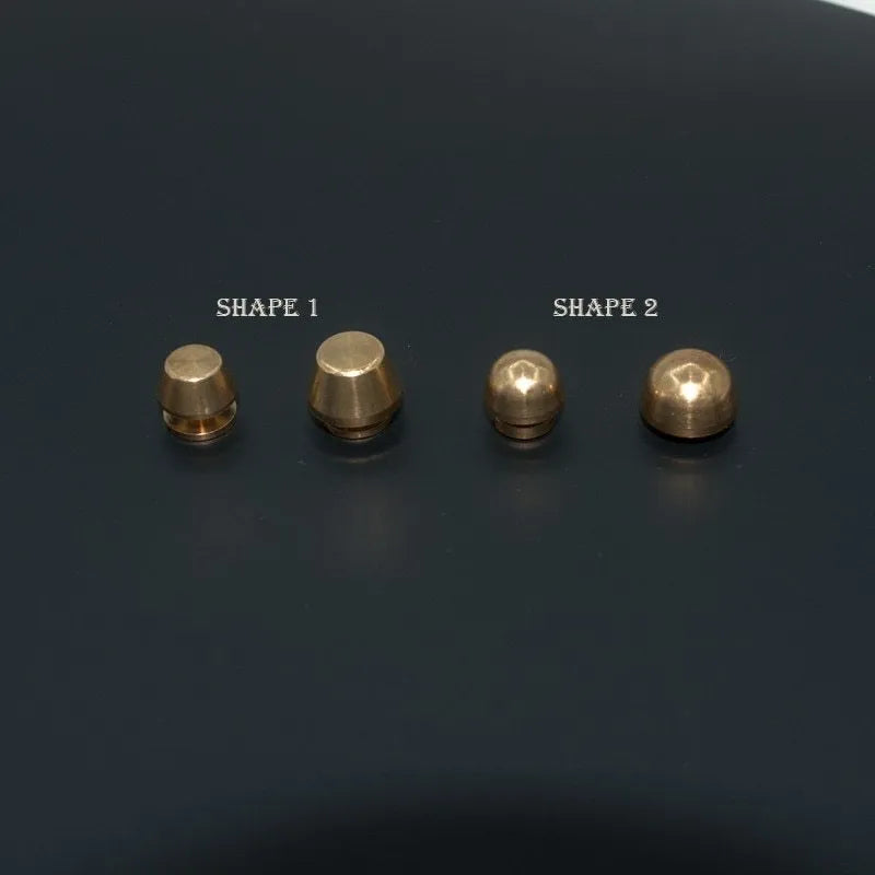 Brass decorative buckle foot nails in round and bucket head shapes, sizes 10x6mm and 12x7mm.