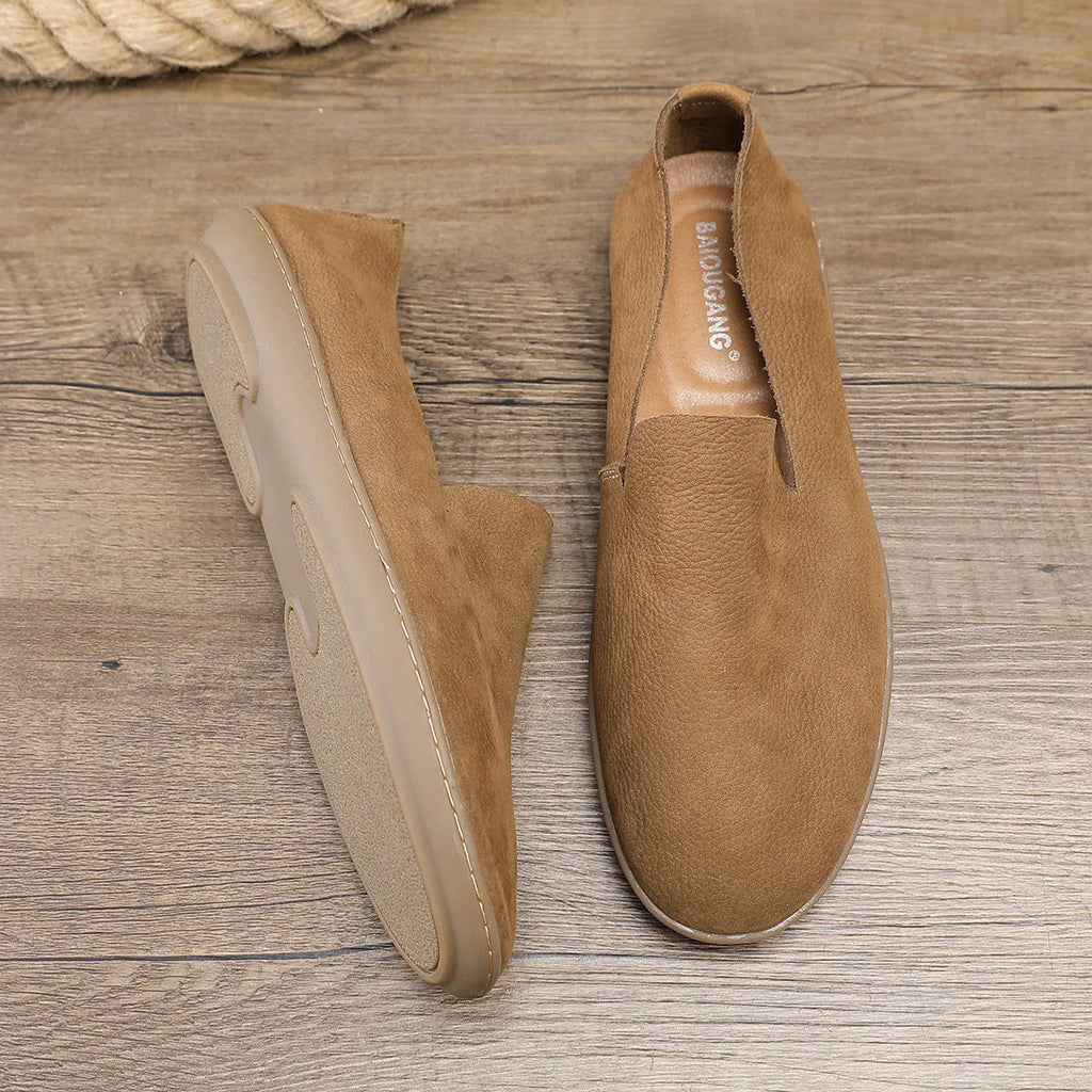 Handmade grey low-top men's casual shoes with a wedge heel and rubber sole on a white background.