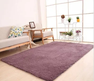 Solid colour fluffy plush carpet with non-slip dots on bottom, shown in beige on a wooden floor.
