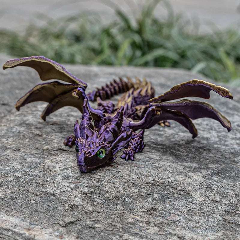3D printed red and gold flying dragon wings decoration toy on a white background.