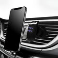 Black car phone holder clipped onto vehicle air vent with phone securely mounted