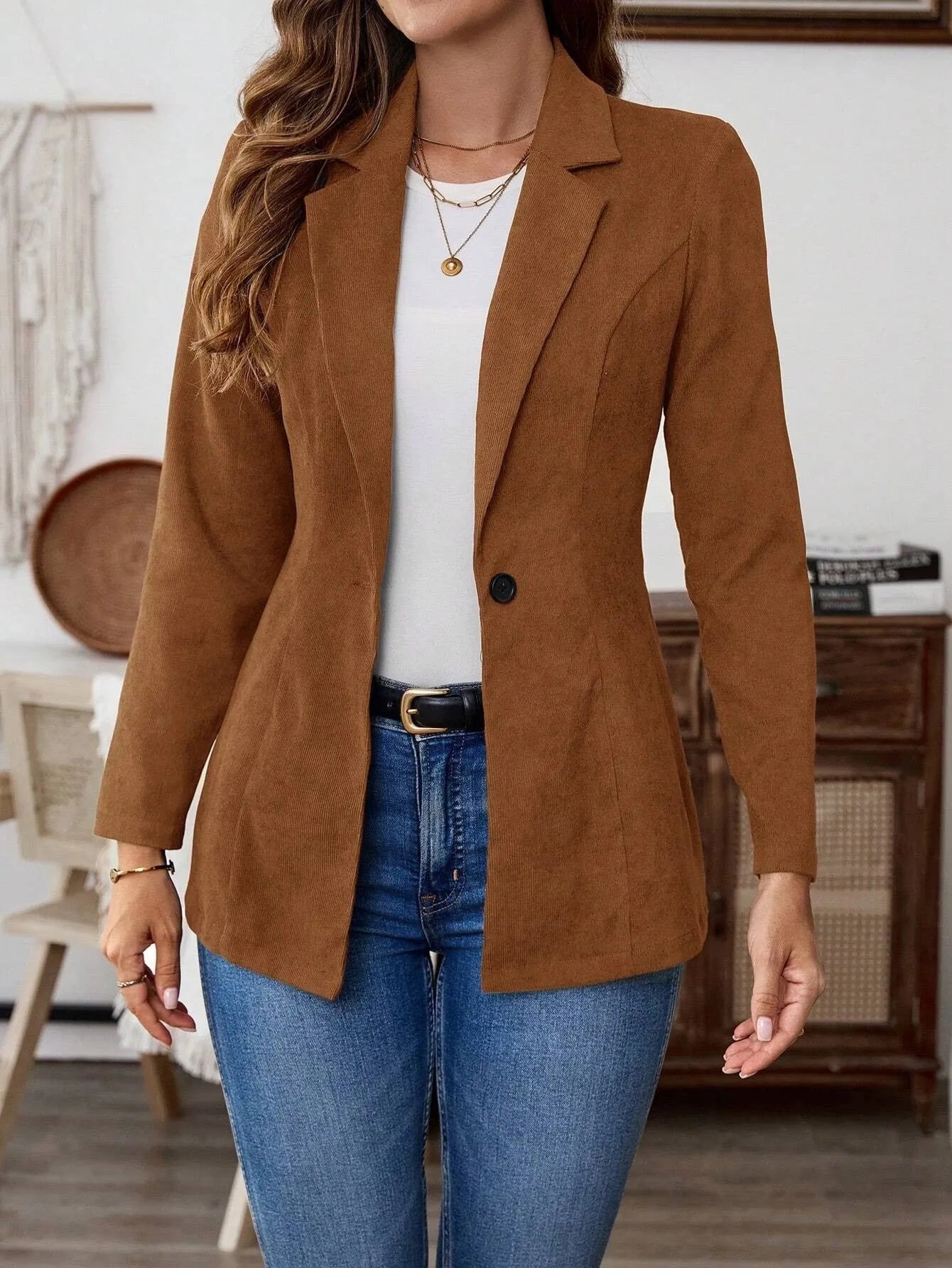 Brown men's lapel long sleeve single-breasted suit coat on a hanger