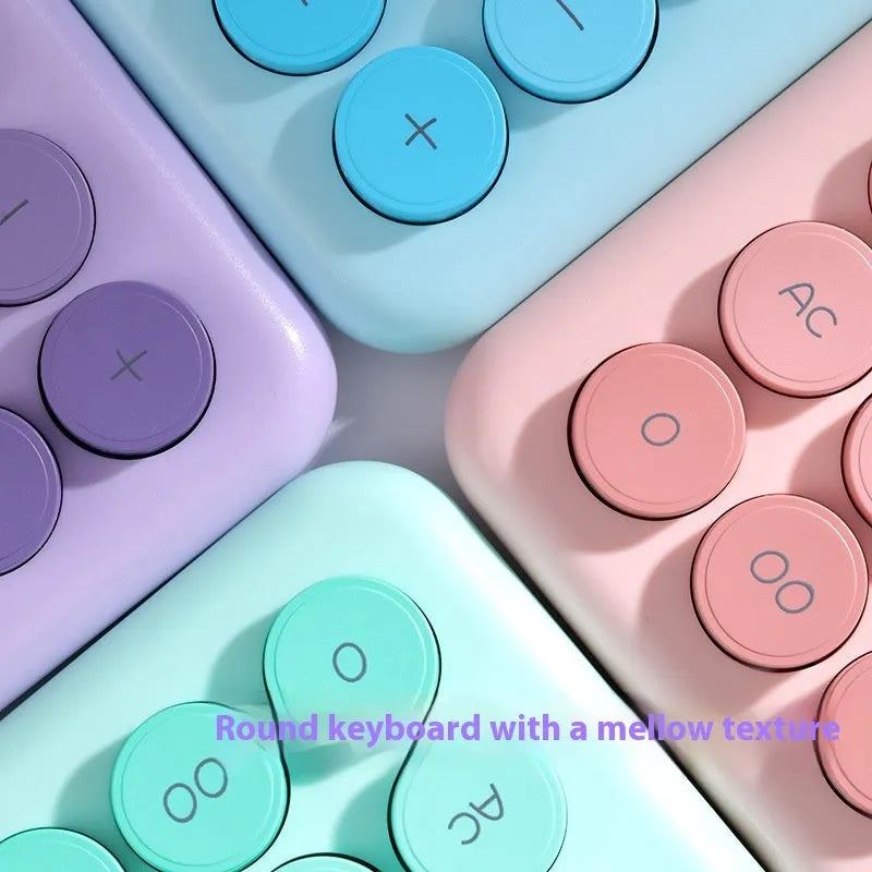 Gradient colour desk calculator in violet, cherry blossom pink, glacier blue, and mint green on a white desk.