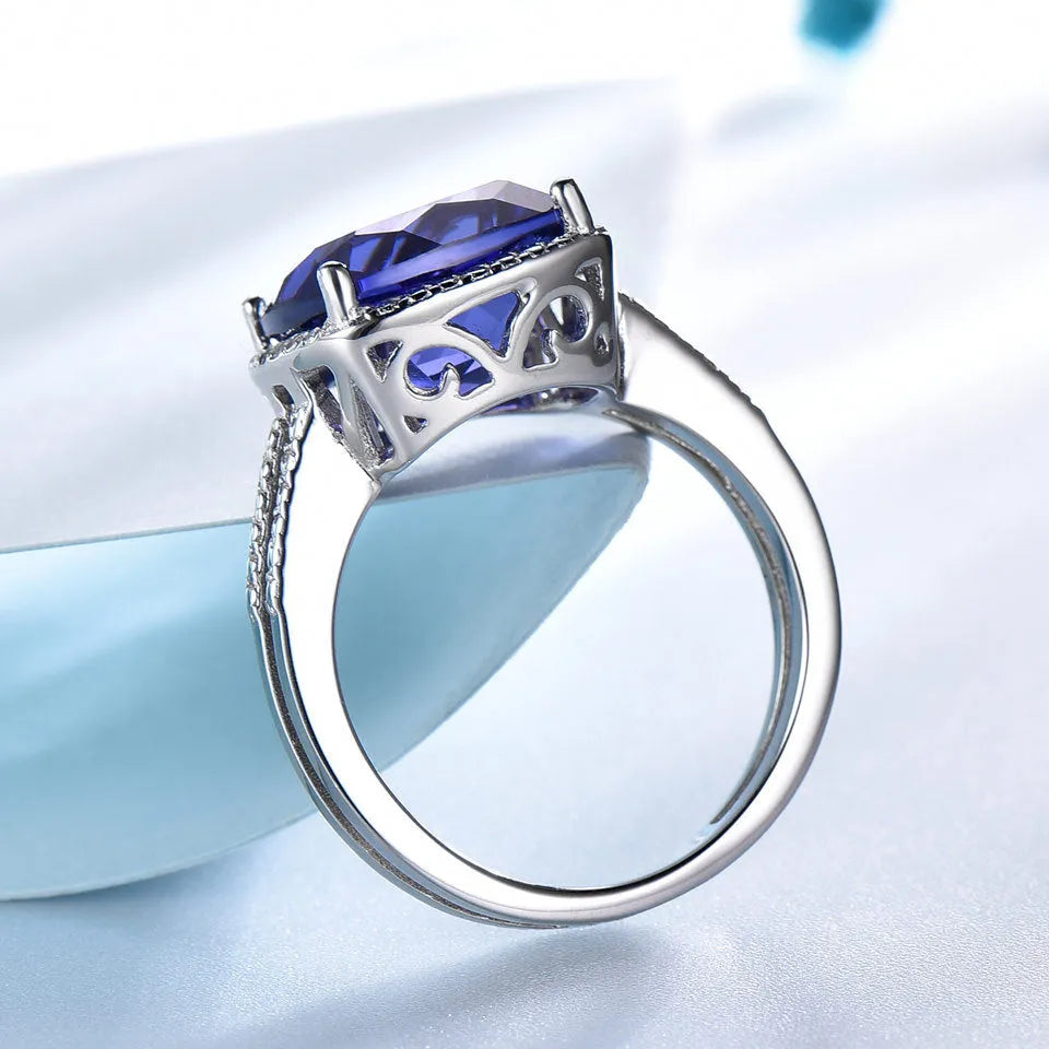 Women's sterling silver ring with blue tanzanite gemstone showing silver band and stone setting