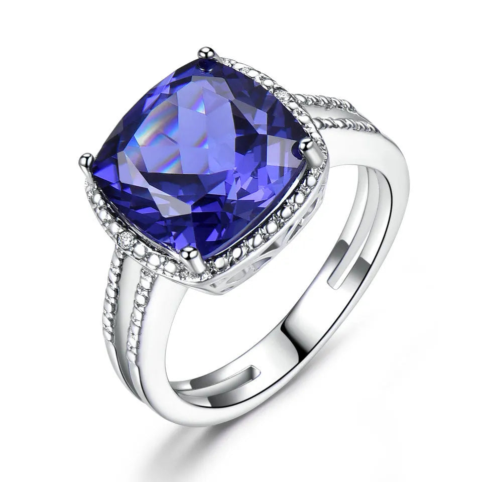 Women's sterling silver ring with blue tanzanite gemstone showing silver band and stone setting
