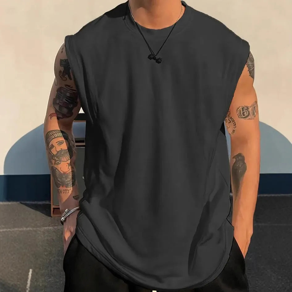 Men's loose fit solid colour cotton tank top shown in a selection of available colours and sizes.