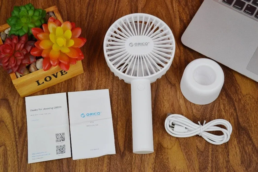 White ORICO FH1 portable USB rechargeable desk fan with fine-line texture on a desktop