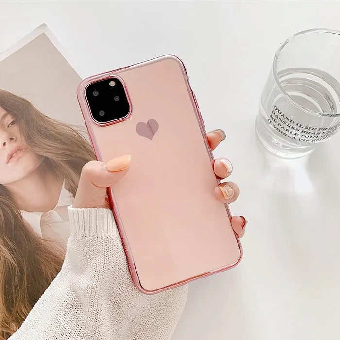 Solid colour TPU back cover case for iPhone on a table, shown in blue, claret, pink, and green.