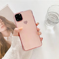 Solid colour TPU back cover case for iPhone on a table, shown in blue, claret, pink, and green.