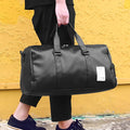 Black waterproof sports bag with diagonal straps and separate shoe compartments in two size options