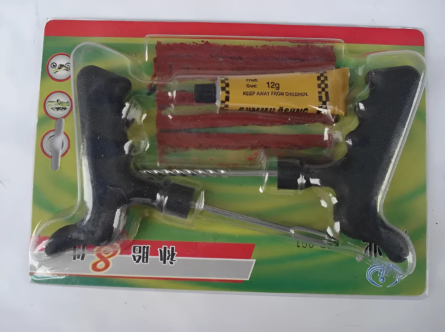 Black and yellow 8-piece vacuum tyre repair tool kit with rubber strips, glue, and metal tools on plastic packaging.