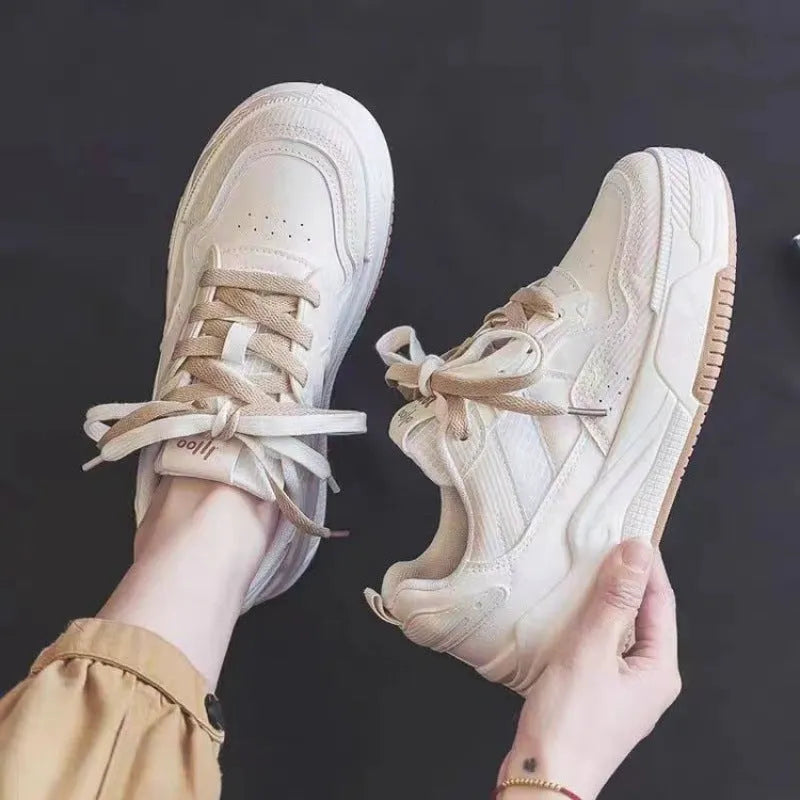 Beige and pink low-top sneakers with rubber soles and imitation leather lining