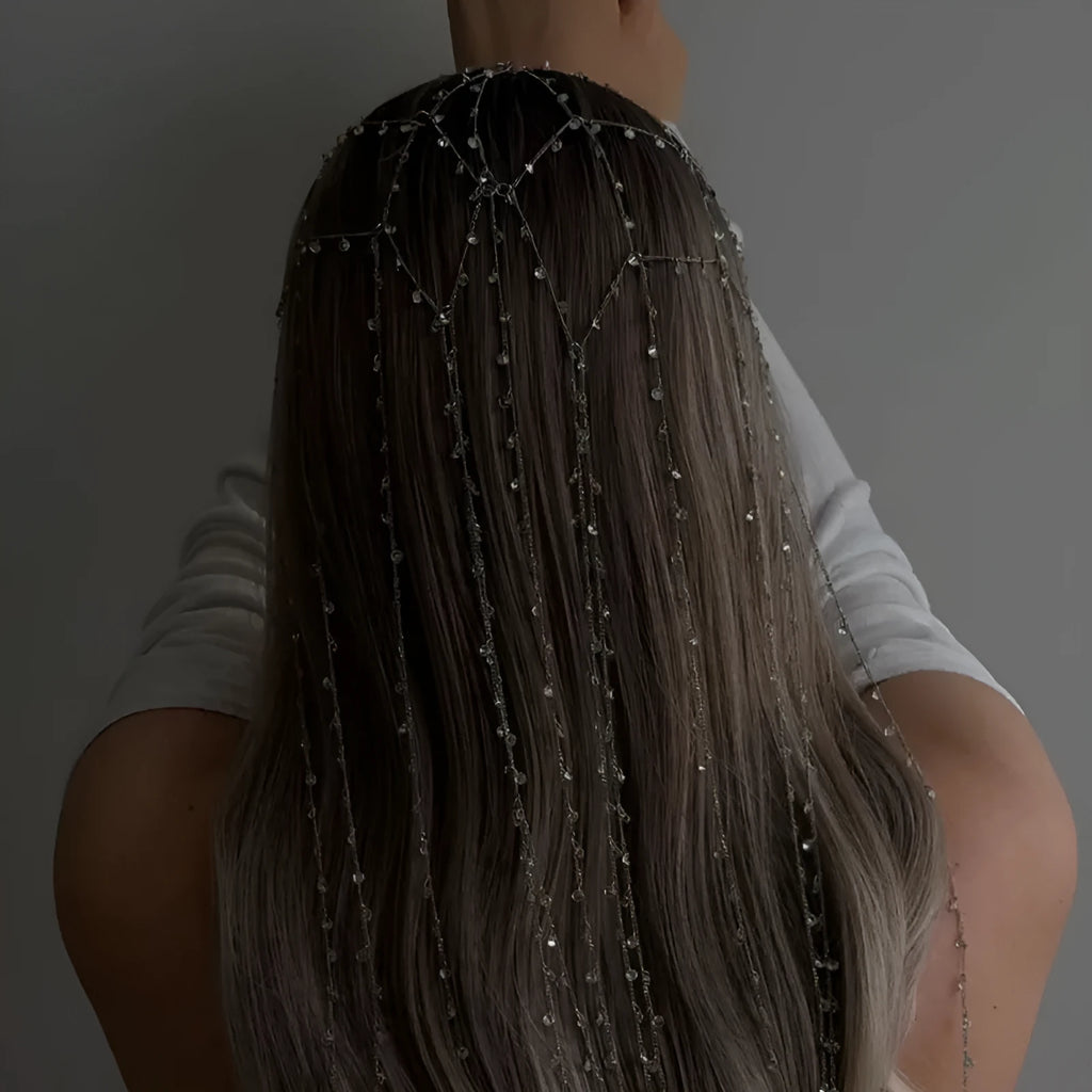 Gold coloured rhinestone hair band with a draped mesh tassel decoration.