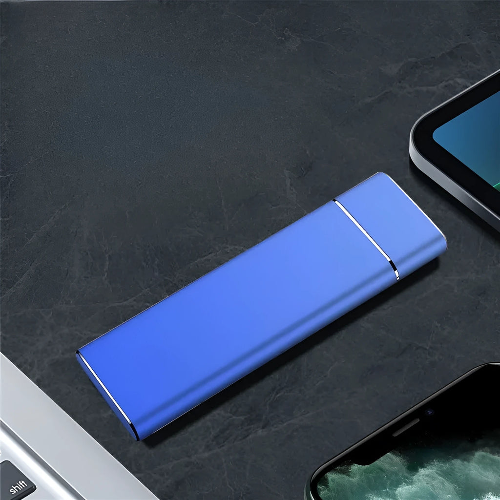 Sapphire blue metal external solid state hard disk with USB cable on a white surface
