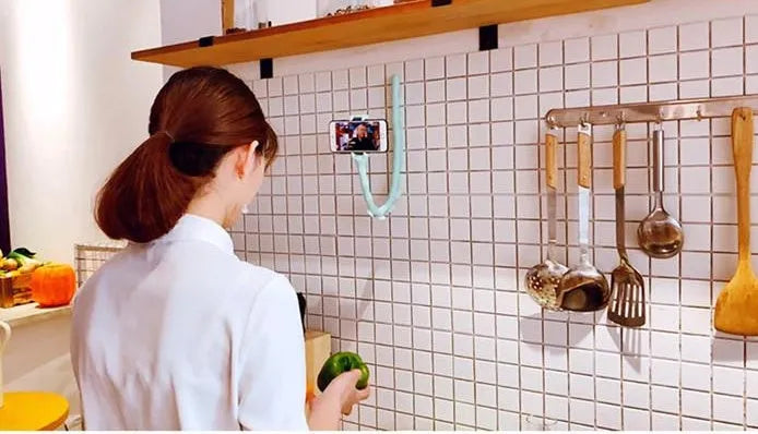Flexible rubber phone holder with suction cup mount showing 360 degree rotation capability