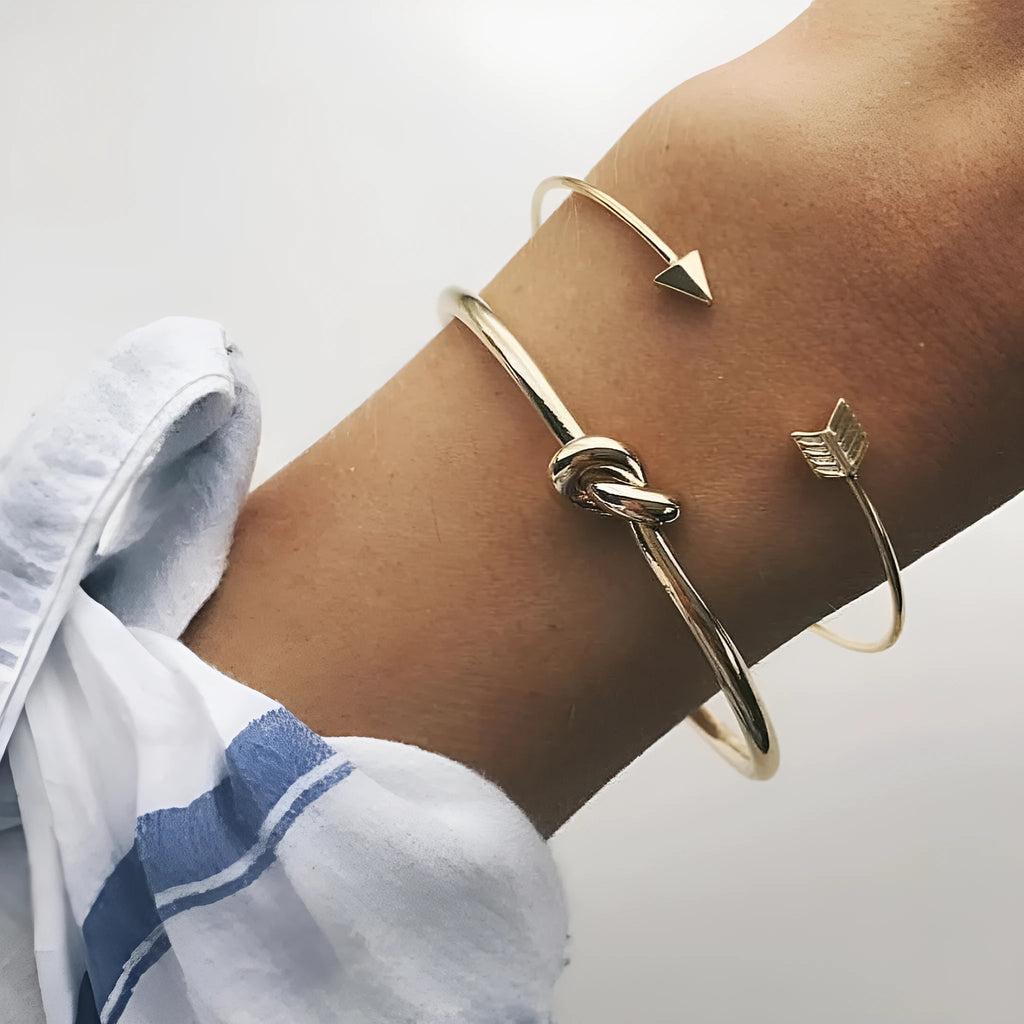 Gold Maili women's vintage cuff bracelet with arrow knot design.
