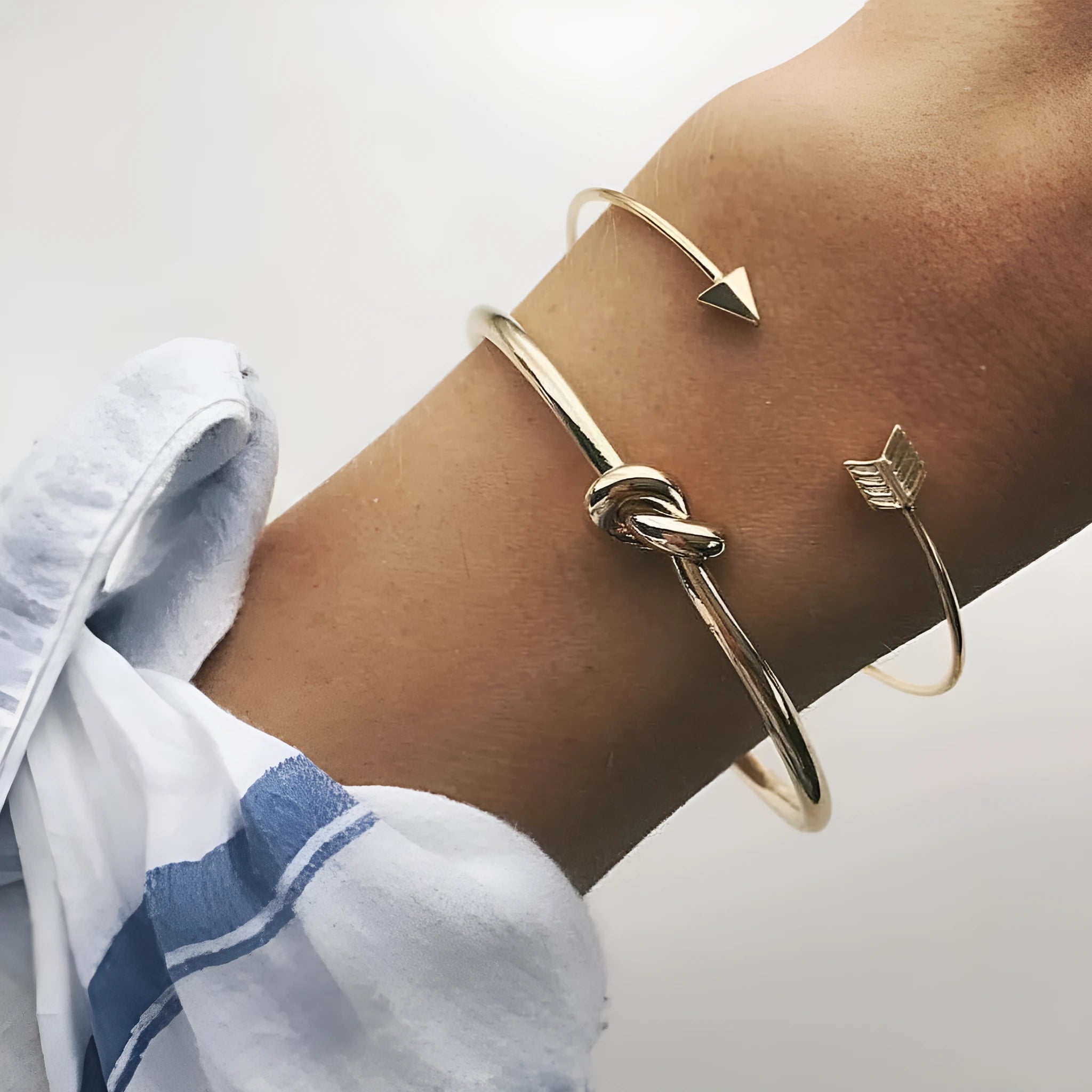 Gold Maili women's vintage cuff bracelet with arrow knot design.