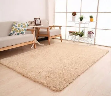 Solid colour fluffy plush carpet with non-slip dots on bottom, shown in beige on a wooden floor.