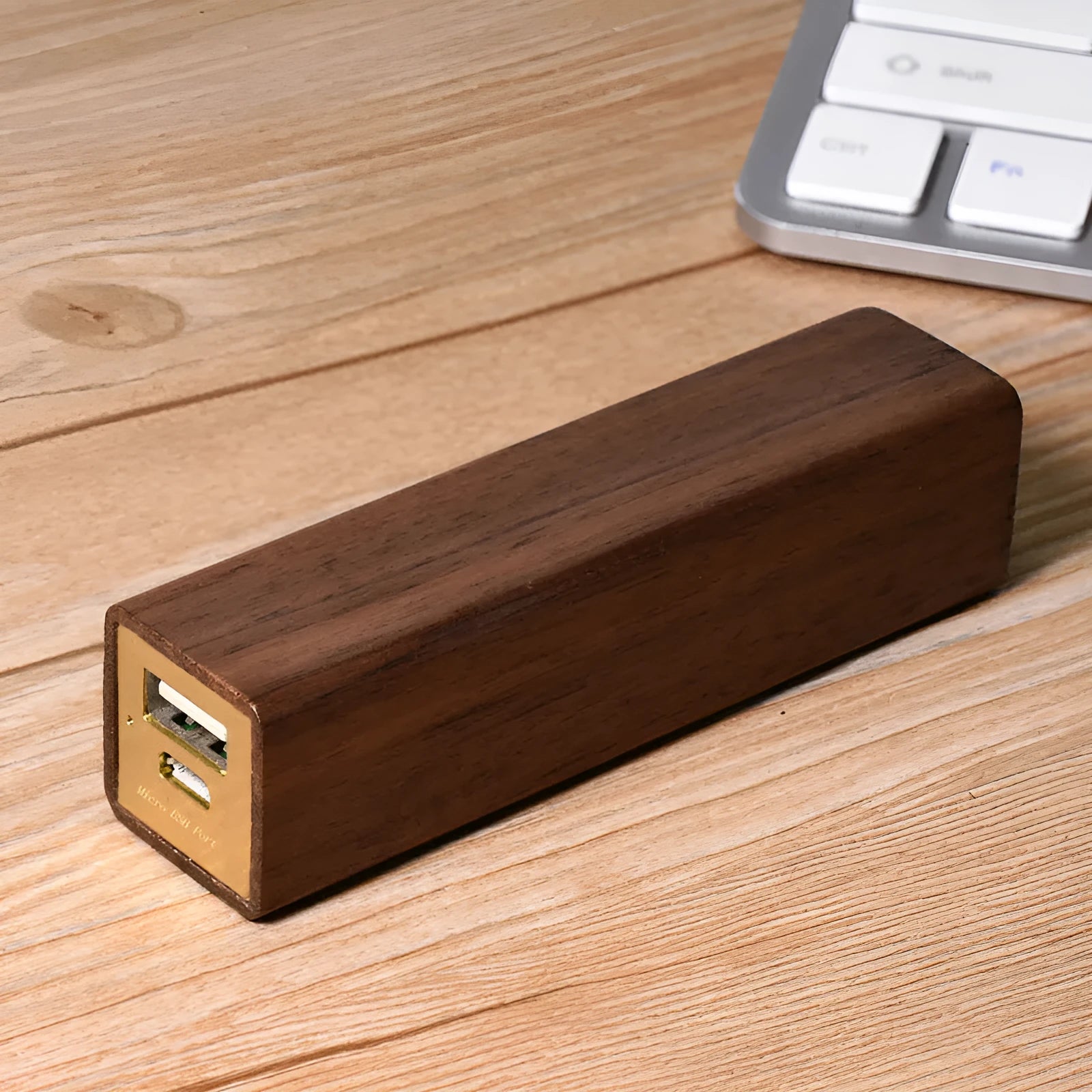 Brown black walnut solid wood portable power bank with 2000mAh capacity.