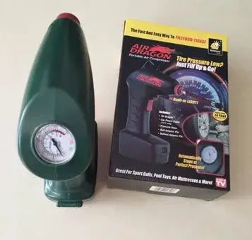 Portable electric car tyre inflator with motor and air pump components on a garage floor.