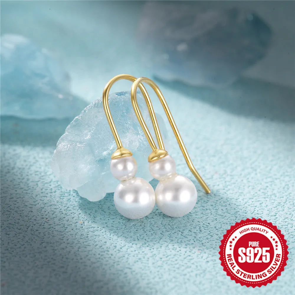 A pair of S925 sterling silver geometric earrings featuring a sunflower design with inlaid golden zircon stones.