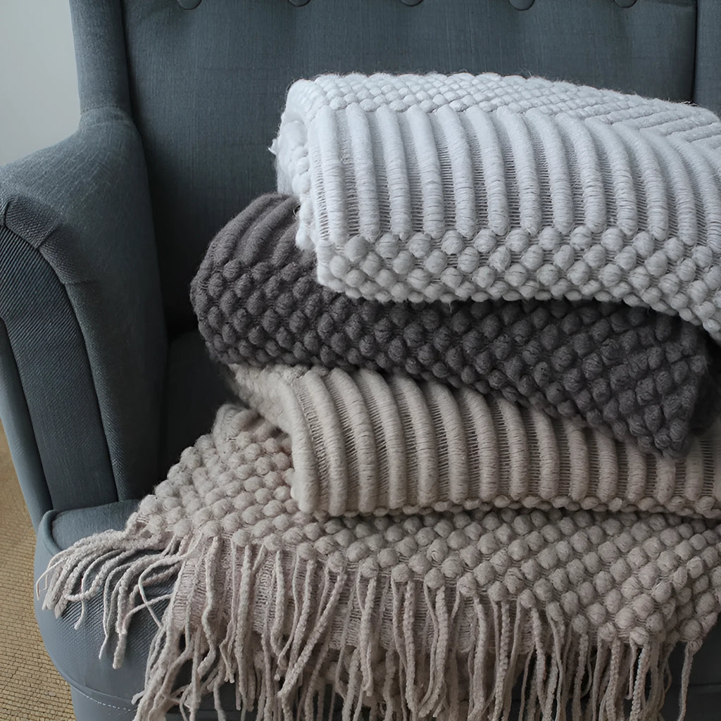 Small grey polyester nap blanket laid flat showing its size.