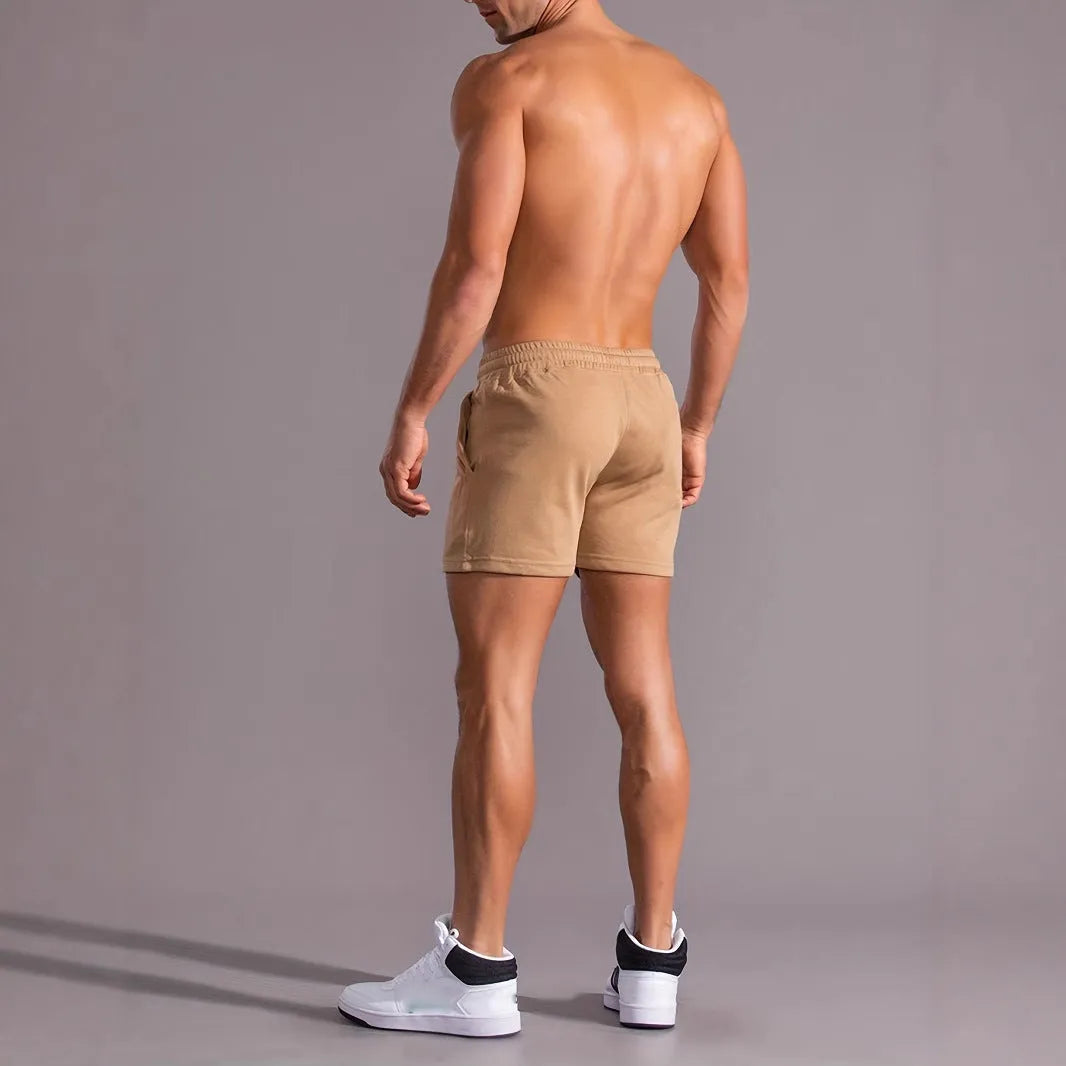 Khaki men's sports shorts with a white coconut leaf print, showing a straight leg and short length.