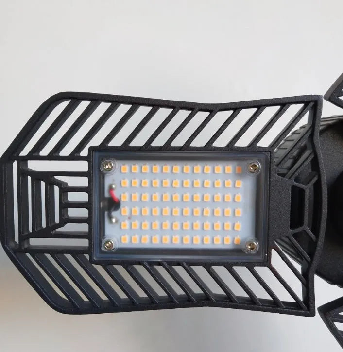 Waterproof industrial foldable garage LED lamp with die-cast aluminium housing on a workbench