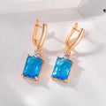 A pair of square geometric copper earrings with a gold electroplated finish.