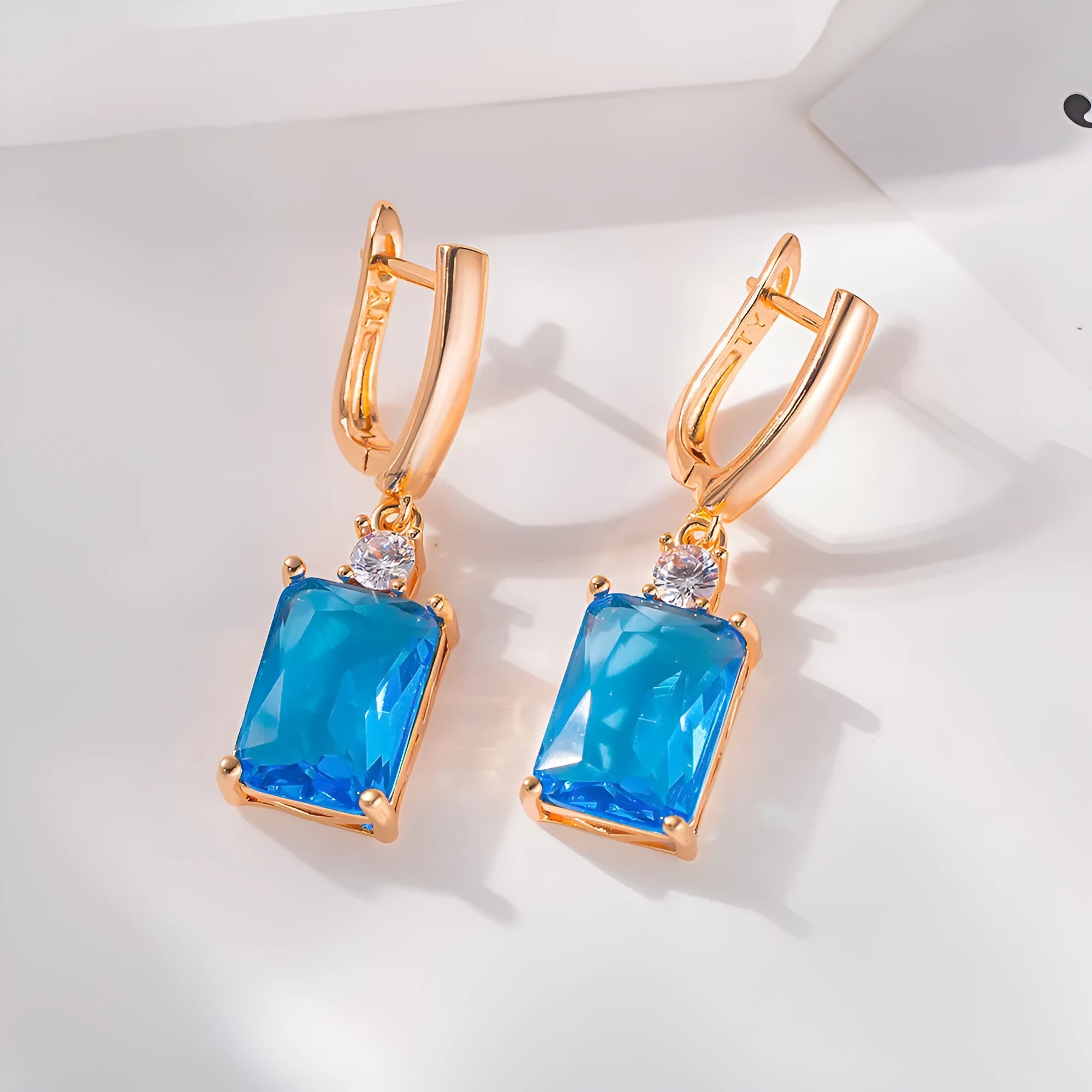 A pair of square geometric copper earrings with a gold electroplated finish.