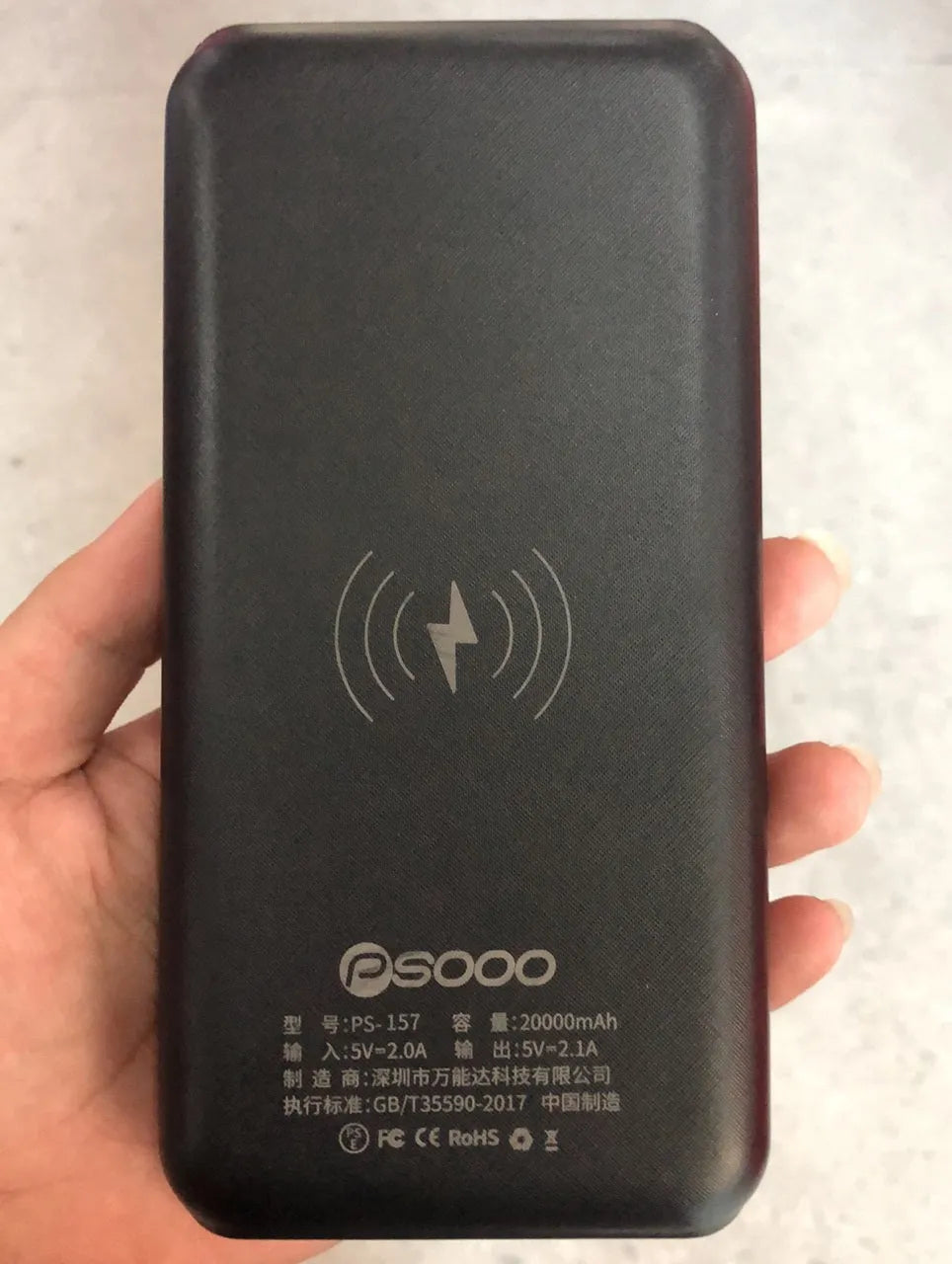 Solar power bank with wireless charging surface, three USB ports, and LED flashlight in black colour