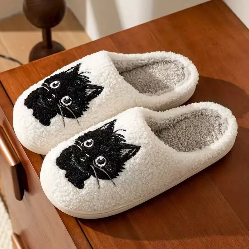 White plush couple slippers with black beard cat cartoon design and non-slip soles.